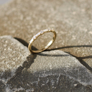 Yellow gold wedding band with baguette cut and round brilliant cut lab diamonds, half side profile view