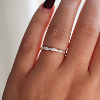 Yellow gold wedding band with baguette cut and round brilliant cut lab diamonds, on hand