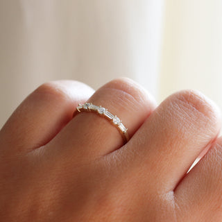 Yellow gold wedding band with baguette cut and round brilliant cut lab diamonds, on hand