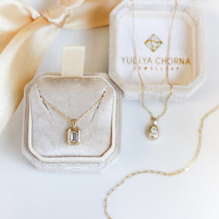 Gold necklaces in Yuliya Chorna jewelry boxes on a white background
