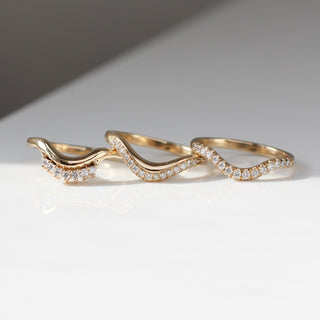 Three curved diamond pave wedding bands in a row, front view