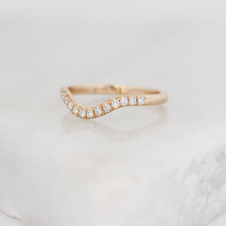Diamond pave curved wedding band in yellow gold, quarter view
