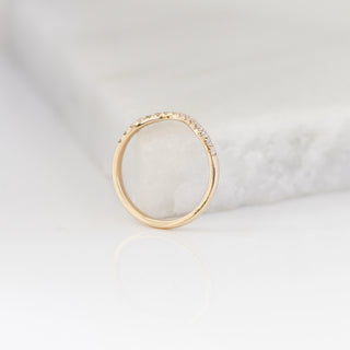 Diamond pave curved wedding band in yellow gold, side profile view