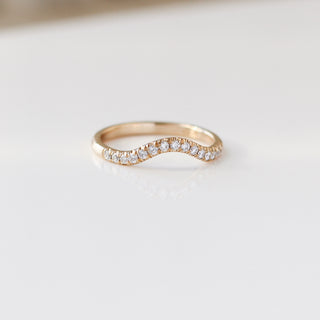 Diamond pave curved wedding band in yellow gold, quarter view