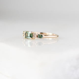 Yellow gold ring with green sapphires, quarter view