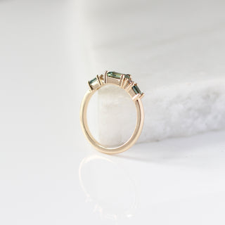 Yellow gold ring with green sapphires, side view