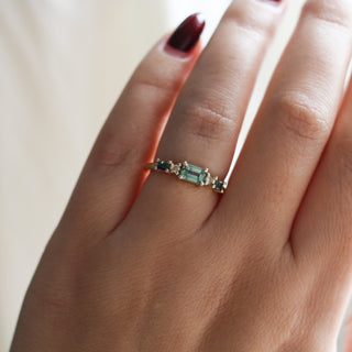 Yellow gold ring with green sapphires on hand