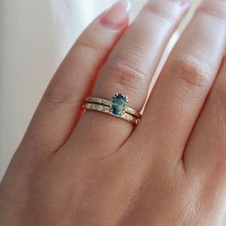 Yellow gold ring with green sapphire with straight yellow gold wedding band with white diamonds, on hand
