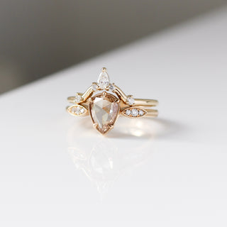 Yellow gold pointed contour band with white diamonds and a yellow gold ring with a champagne diamond, front view