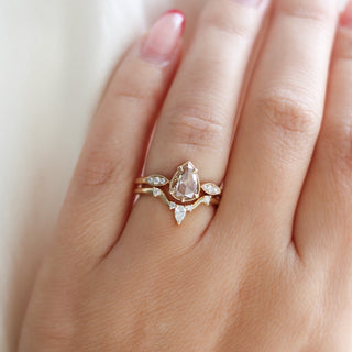 Yellow gold pointed contour band with white diamonds and a yellow gold ring with a champagne diamond, on hand