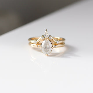 Yellow gold pointed contour band with white diamonds and a yellow gold ring with a white diamond, front view