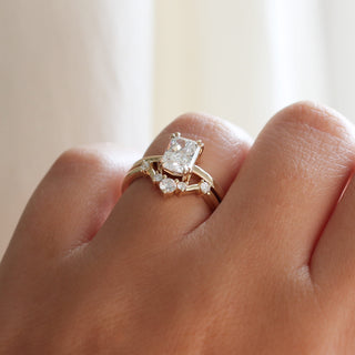 Yellow gold contour band with white diamonds and a yellow gold ring with a white diamond, on hand