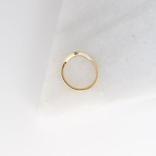 Large Wave Gold Wedding Band profile view on marble