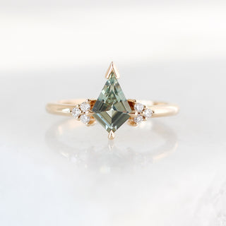 Yellow gold ring with a light green kite cut sapphire, front view