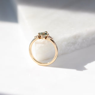 Yellow gold ring with a light green kite cut sapphire, side view
