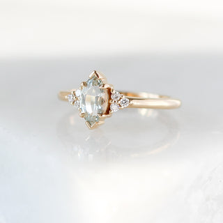 Yellow gold ring with a light green marquise cut sapphire, quarter view