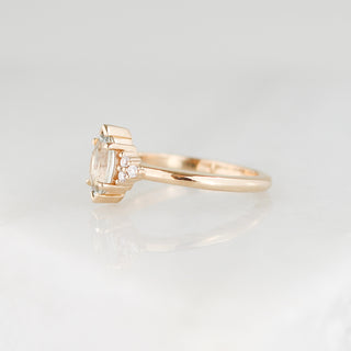 Yellow gold ring with a light green marquise cut sapphire, half view