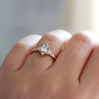 Yellow gold ring with a light green marquise cut sapphire, on hand