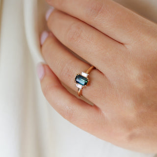 Emerald cut green sapphire ring with baguette side stones in yellow gold, on hand