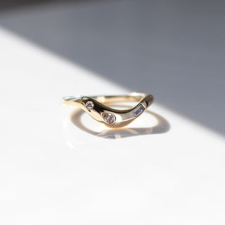 Yellow gold contour band with clear diamonds, front view