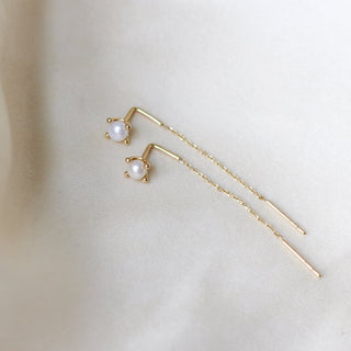 Pearl Threader Earrings in yellow gold on white fabric