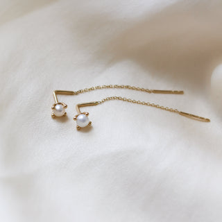 Pearl Threader Earrings in yellow gold on white fabric