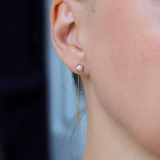 Pearl Threader Earrings in yellow gold being worn close up