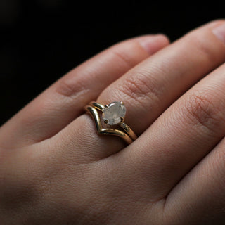 Point Gold band stacked with oval diamond solitaire ring, on hand