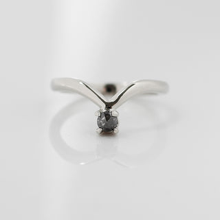 Pointed platinum wedding band with one round salt and pepper diamond at the point. 
