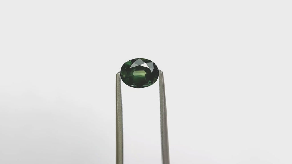 green oval cut sapphire in tongs video