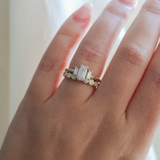 Yellow gold straight band with white diamonds and a yellow gold ring with white diamonds, on hand