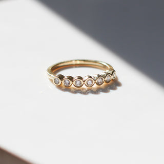 Yellow gold straight band with white diamonds, front view
