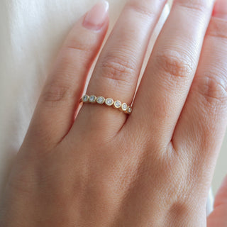 Yellow gold straight band with white diamonds, on hand