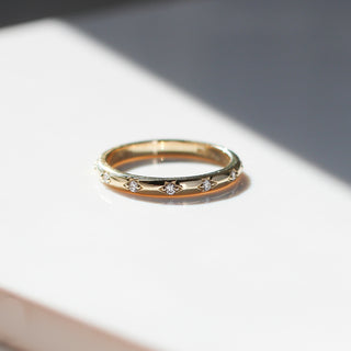 Yellow gold straight band with star-set white diamonds, front view