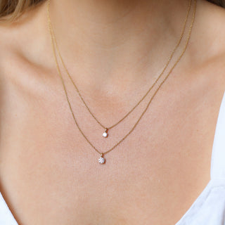 Two Round Lab Diamond Necklaces in yellow gold being worn