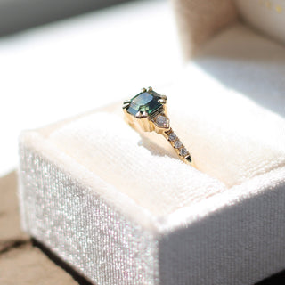 Square cut green sapphire ring in yellow gold in ring box