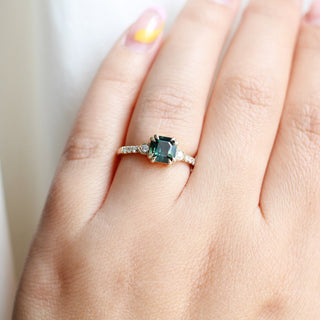 Square cut green sapphire ring in yellow gold on hand