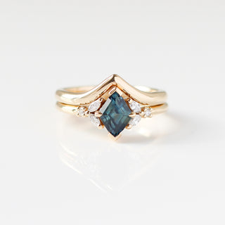 Yellow gold ring with a teal lozenge cut sapphire and white diamond accents with a yellow gold pointed wedding band, front view