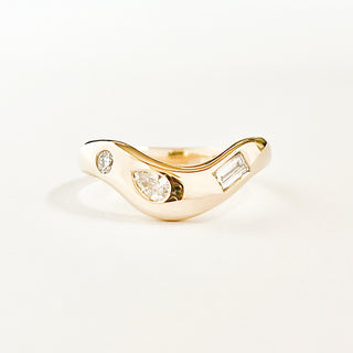 Thick organic style curved wedding band in yellow gold, with three different shaped diamonds set into the band. 