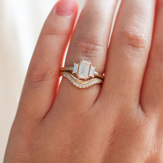 Twilight diamond wave band stacked with an emerald cut white diamond engagement ring, on hand