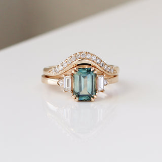 Twilight diamond wave band stacked with an emerald cut green sapphire engagement ring, front view
