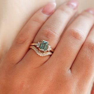 Twilight diamond wave band stacked with an emerald cut green sapphire engagement ring, on hand
