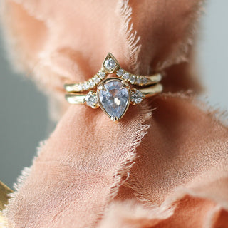 Kite Diamond Point Band stacked with oval sapphire diamond ring over cloth