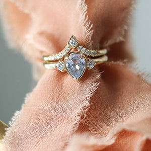 Kite Diamond Point Band stacked with oval sapphire diamond ring over cloth