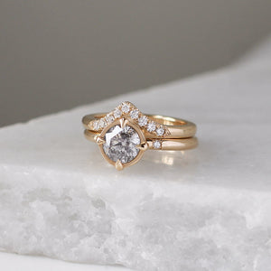 Diamond Point Gold Band stacked with round diamond ring on marble quarter view