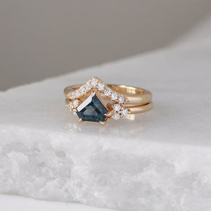 Diamond Point Gold Band stacked with sapphire diamond ring on marble quarter view