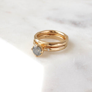 Faceted Textured Yellow Gold Ring stacked with a diamond ring quarter view