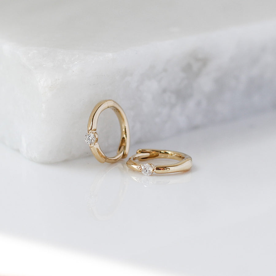 Floating Diamond Gold Hoops on marble 