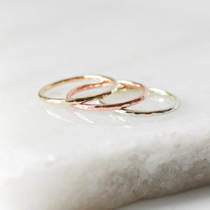 Hammered Thin Band in yellow and red and white gold  on marble
