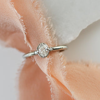 Oval cut diamond ring in yellow gold over cloth